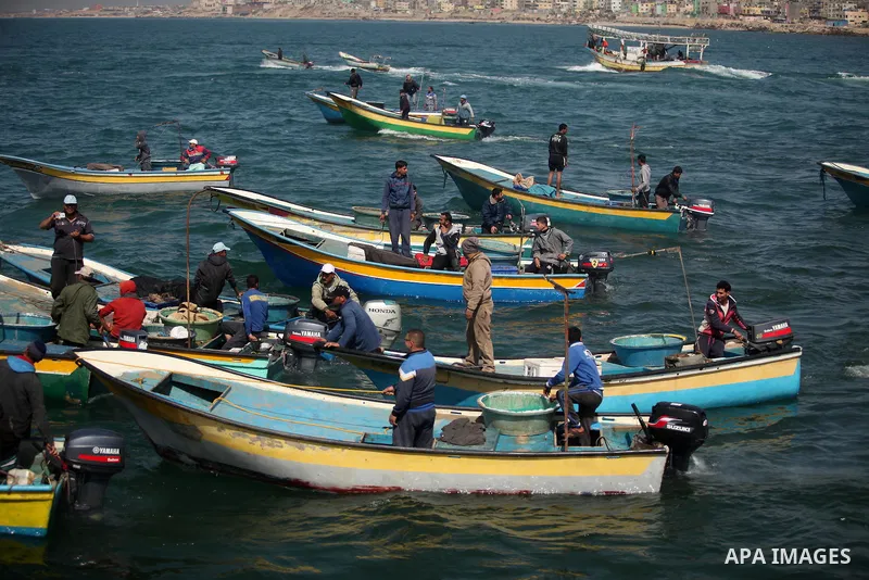 Palestinian fishermen ride their fishing boat at the beach of Gaza City on April 03, 2016. Israel on Sunday extended the distance it permits Gaza fishermen to head out to sea along certain parts of the coastline of the e...