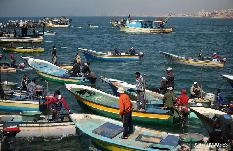 Palestinian fishermen ride their fishing boat at the beach of Gaza City on April 03, 2016. Israel on Sunday extended the distance it permits Gaza fishermen to head out to sea along certain parts of the coastline of the e...