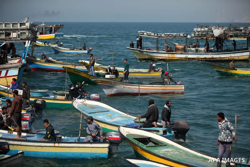 Palestinian fishermen ride their fishing boat at the beach of Gaza City on April 03, 2016. Israel on Sunday extended the distance it permits Gaza fishermen to head out to sea along certain parts of the coastline of the e...