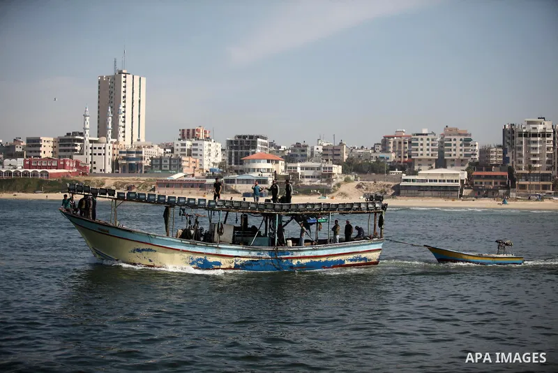 Palestinian fishermen ride their fishing boat at the beach of Gaza City on April 03, 2016. Israel on Sunday extended the distance it permits Gaza fishermen to head out to sea along certain parts of the coastline of the e...