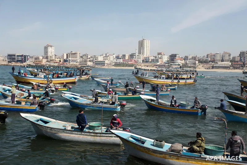 Palestinian fishermen ride their fishing boat at the beach of Gaza City on April 03, 2016. Israel on Sunday extended the distance it permits Gaza fishermen to head out to sea along certain parts of the coastline of the e...