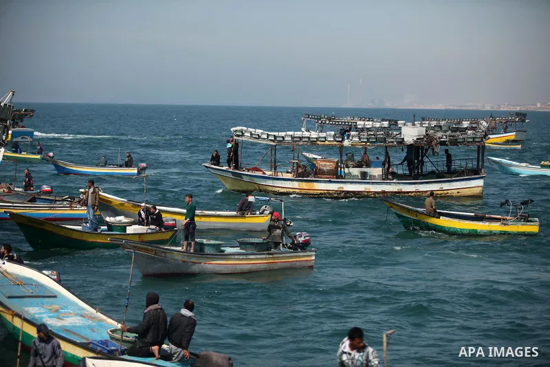 Palestinian fishermen ride their fishing boat at the beach of Gaza City on April 03, 2016. Israel on Sunday extended the distance it permits Gaza fishermen to head out to sea along certain parts of the coastline of the e...