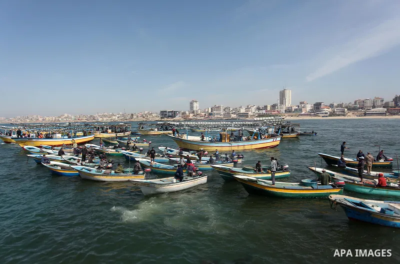 Palestinian fishermen ride their fishing boat at the beach of Gaza City on April 03, 2016. Israel on Sunday extended the distance it permits Gaza fishermen to head out to sea along certain parts of the coastline of the e...
