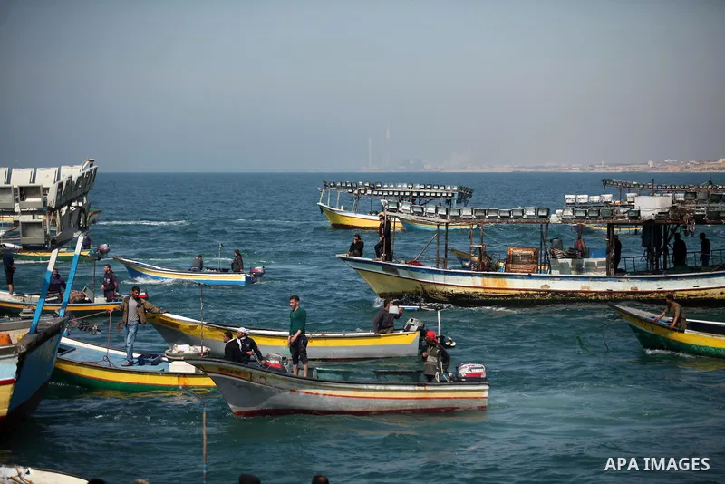 Palestinian fishermen ride their fishing boat at the beach of Gaza City on April 03, 2016. Israel on Sunday extended the distance it permits Gaza fishermen to head out to sea along certain parts of the coastline of the e...