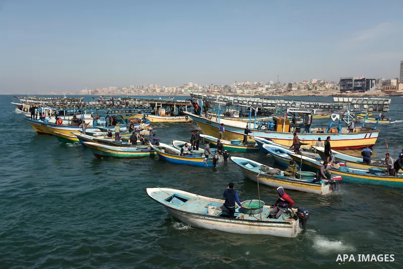 Palestinian fishermen ride their fishing boat at the beach of Gaza City on April 03, 2016. Israel on Sunday extended the distance it permits Gaza fishermen to head out to sea along certain parts of the coastline of the e...