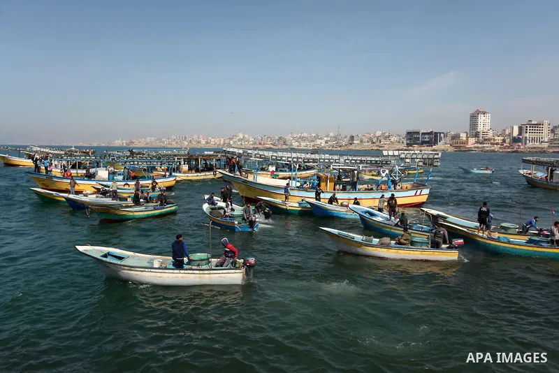 Palestinian fishermen ride their fishing boat at the beach of Gaza City on April 03, 2016. Israel on Sunday extended the distance it permits Gaza fishermen to head out to sea along certain parts of the coastline of the e...