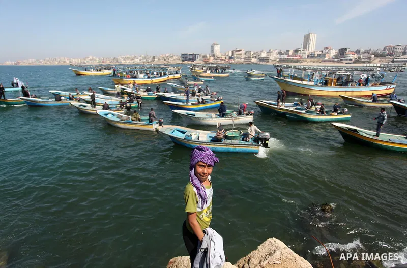Palestinian fishermen ride their fishing boat at the beach of Gaza City on April 03, 2016. Israel on Sunday extended the distance it permits Gaza fishermen to head out to sea along certain parts of the coastline of the e...