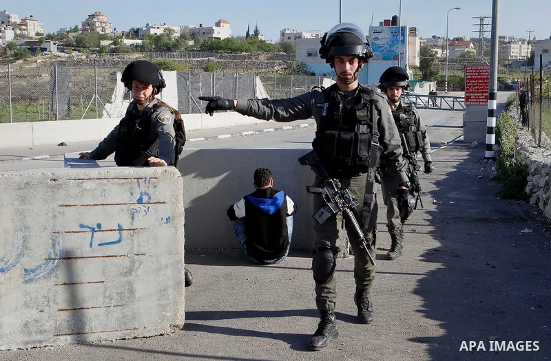 Israeli border policemen arrest a Palestinian man at the Beit Ainun junction near the West Bank city of Hebron, on April 4, 2016. The man reportedly was arrested within the usual security measures taken in the region by...