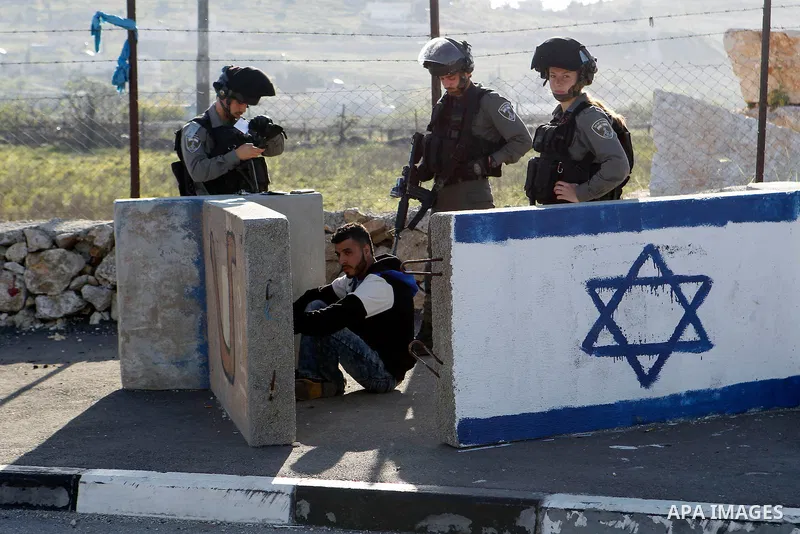 Israeli border policemen arrest a Palestinian man at the Beit Ainun junction near the West Bank city of Hebron, on April 4, 2016. The man reportedly was arrested within the usual security measures taken in the region by...