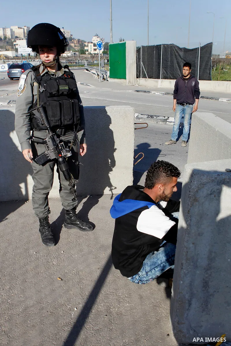 Israeli border policemen arrest a Palestinian man at the Beit Ainun junction near the West Bank city of Hebron, on April 4, 2016. The man reportedly was arrested within the usual security measures taken in the region by...