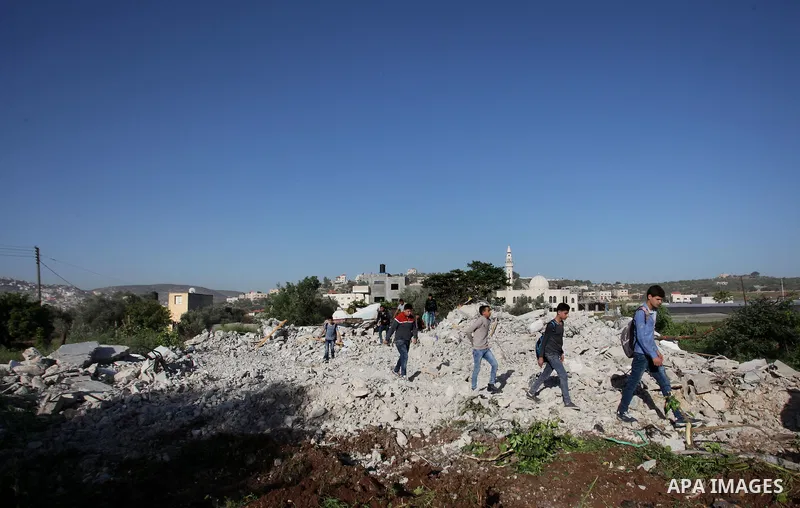 Palestinians inspect the rubble of of their house that were demolished by the Israeli bulldozers, in the village of Qabatiya south of Jenin, on April 4, 2016. The three Palestinians to whom the houses belonged were shot...