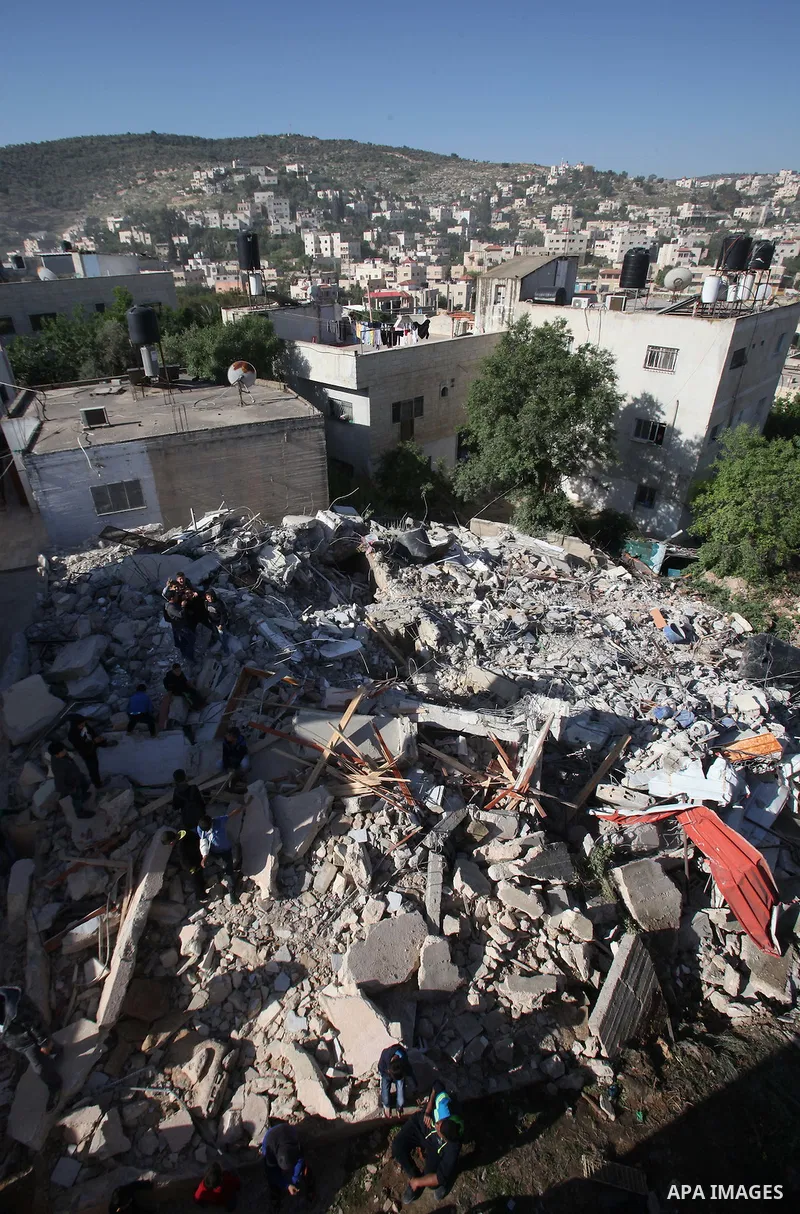 Palestinians inspect the rubble of of their house that were demolished by the Israeli bulldozers, in the village of Qabatiya south of Jenin, on April 4, 2016. The three Palestinians to whom the houses belonged were shot...