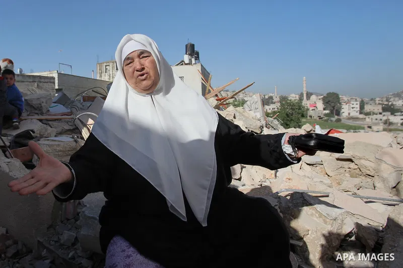 Palestinians inspect the rubble of of their house that were demolished by the Israeli bulldozers, in the village of Qabatiya south of Jenin, on April 4, 2016. The three Palestinians to whom the houses belonged were shot...
