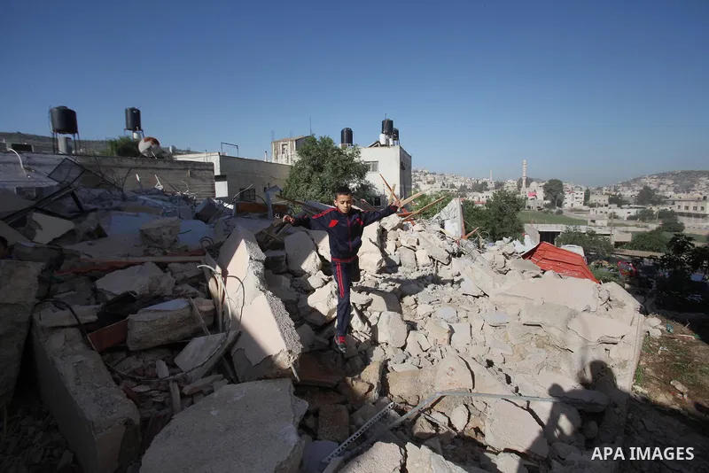 Palestinians inspect the rubble of of their house that were demolished by the Israeli bulldozers, in the village of Qabatiya south of Jenin, on April 4, 2016. The three Palestinians to whom the houses belonged were shot...