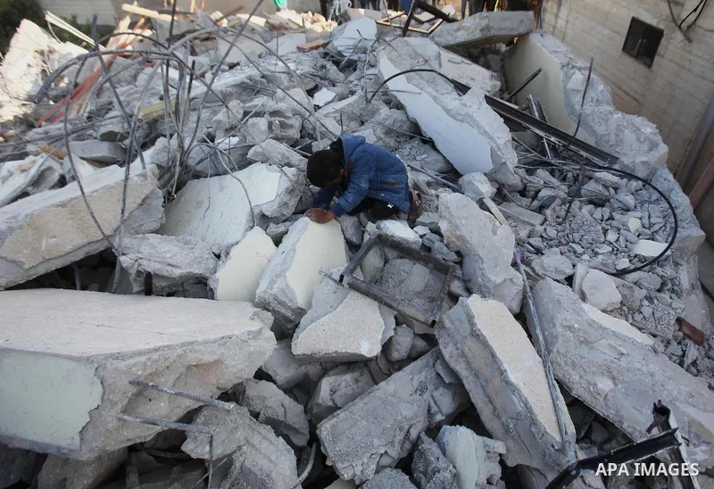 Palestinians inspect the rubble of of their house that were demolished by the Israeli bulldozers, in the village of Qabatiya south of Jenin, on April 4, 2016. The three Palestinians to whom the houses belonged were shot...