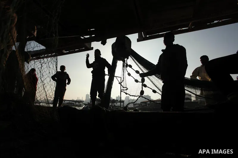 Palestinian fishermen pull their net at the beach in Gaza City, on April 4, 2016. Israel on Sunday extended the distance it permits Gaza fishermen to head out to sea along certain parts of the coastline of the enclave, w...
