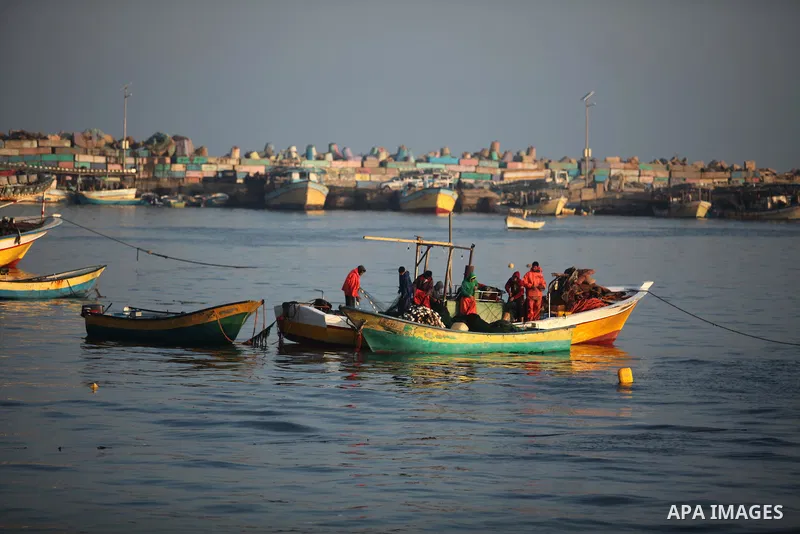 Palestinian fishermen ride their fishing boat at the beach of Gaza City, on April 4, 2016. Israel on Sunday extended the distance it permits Gaza fishermen to head out to sea along certain parts of the coastline of the e...