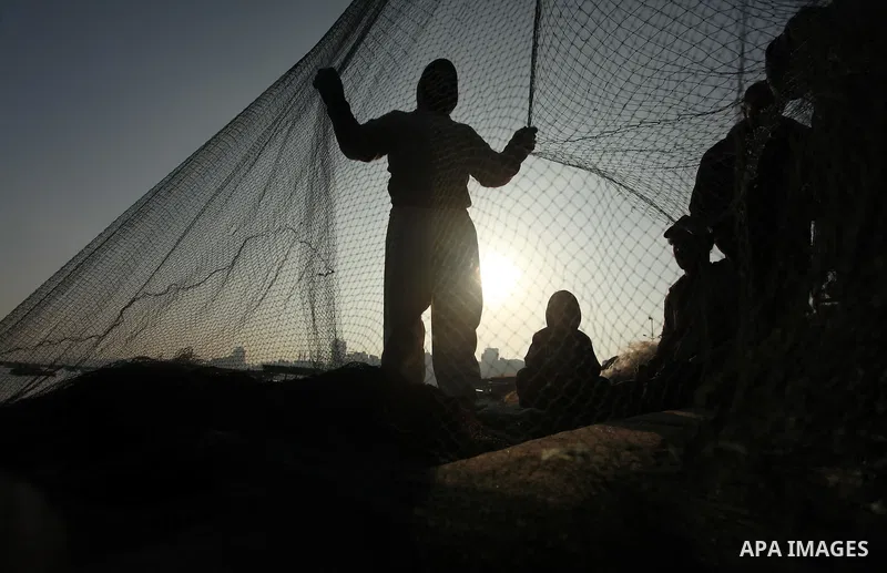 Palestinian fishermen pull their net at the beach in Gaza City, on April 4, 2016. Israel on Sunday extended the distance it permits Gaza fishermen to head out to sea along certain parts of the coastline of the enclave, w...