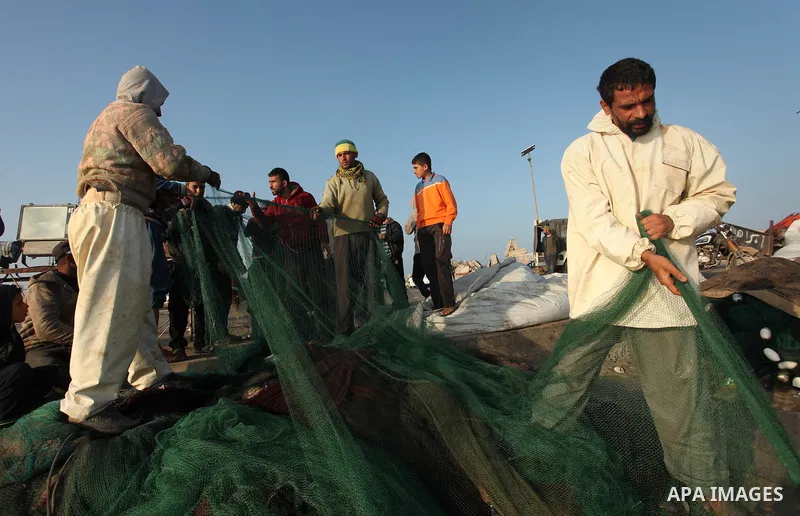 Palestinian fishermen pull their net at the beach in Gaza City, on April 4, 2016. Israel on Sunday extended the distance it permits Gaza fishermen to head out to sea along certain parts of the coastline of the enclave, w...