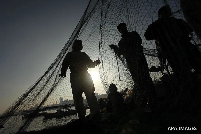 Palestinian fishermen pull their net at the beach in Gaza City, on April 4, 2016. Israel on Sunday extended the distance it permits Gaza fishermen to head out to sea along certain parts of the coastline of the enclave, w...