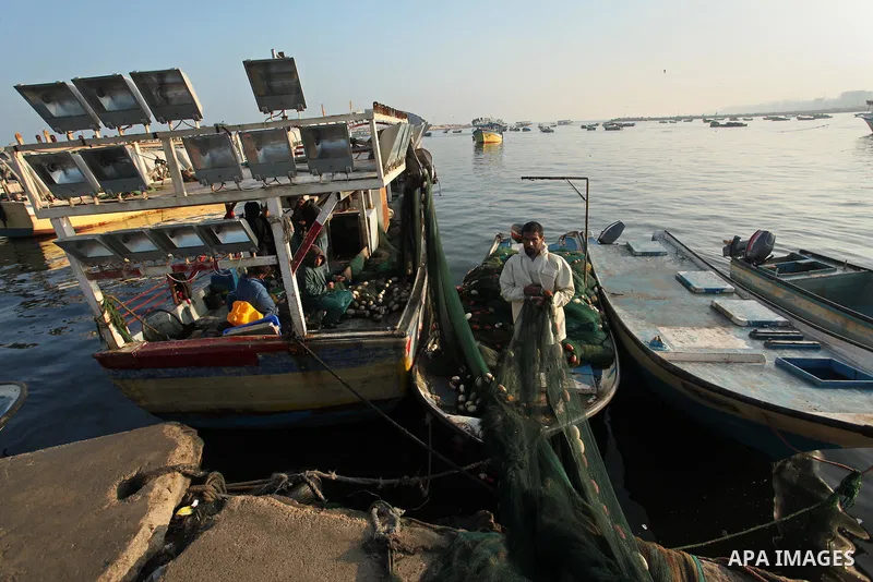 Palestinian fishermen pull their net at the beach in Gaza City, on April 4, 2016. Israel on Sunday extended the distance it permits Gaza fishermen to head out to sea along certain parts of the coastline of the enclave, w...