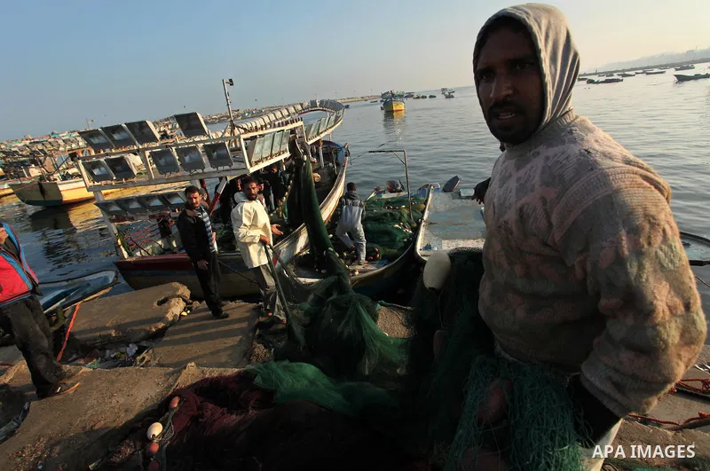 Palestinian fishermen pull their net at the beach in Gaza City, on April 4, 2016. Israel on Sunday extended the distance it permits Gaza fishermen to head out to sea along certain parts of the coastline of the enclave, w...