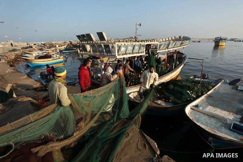 Palestinian fishermen pull their net at the beach in Gaza City, on April 4, 2016. Israel on Sunday extended the distance it permits Gaza fishermen to head out to sea along certain parts of the coastline of the enclave, w...
