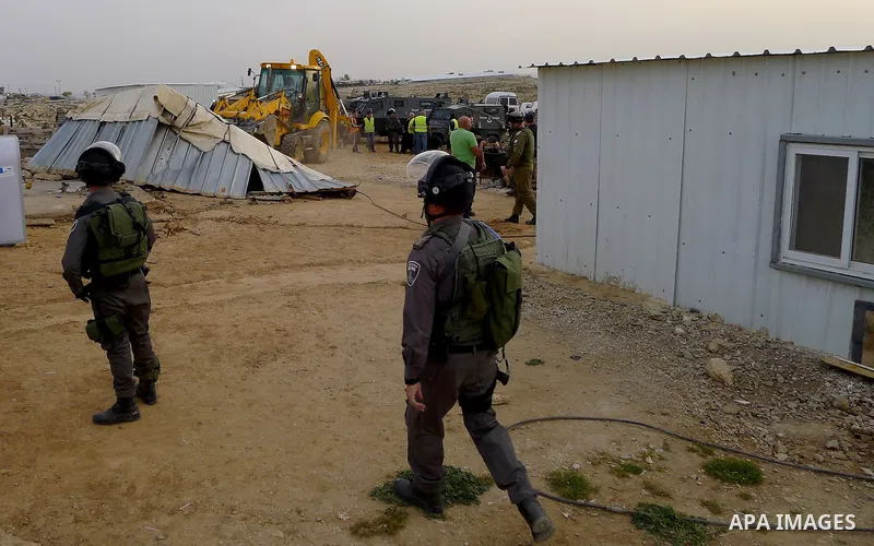 Israeli troops stand guard as bulldozers demolish houses in the West Bank village of Um Alkahiar, South of Hebron 06 April 2016. Israeli forces on Wednesday demolished six structures in Khirbet Umm al-Kheir south of the...