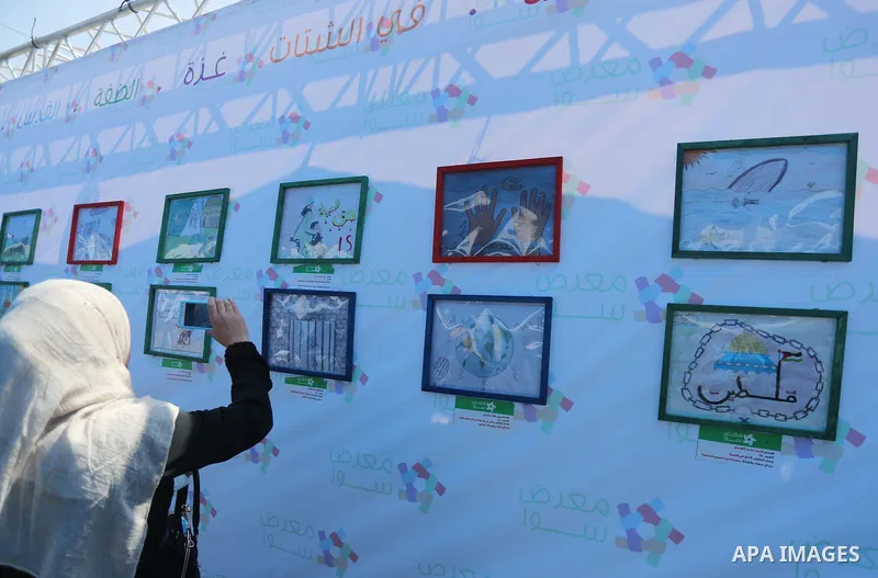 Palestinians attend a photo gallery to mark Palestinian child day in Gaza seaport, on April 6, 2016. Photo by Mohammed Asad