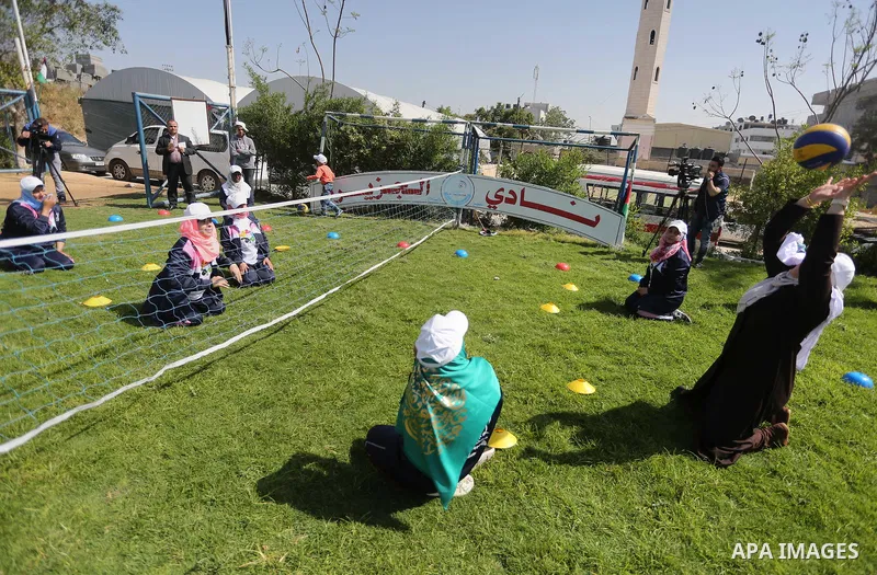 Disabled Palestinians play sitting volleyball during a local sports championship organized by Al Jazeera club in Gaza City April 7, 2016. Photo by Mohammed Asad