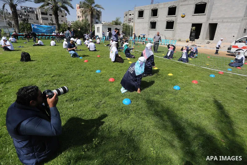 Disabled Palestinians play sitting volleyball during a local sports championship organized by Al Jazeera club in Gaza City April 7, 2016. Photo by Mohammed Asad