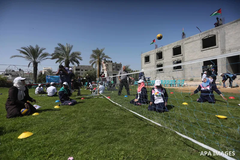 Disabled Palestinians play sitting volleyball during a local sports championship organized by Al Jazeera club in Gaza City April 7, 2016. Photo by Mohammed Asad