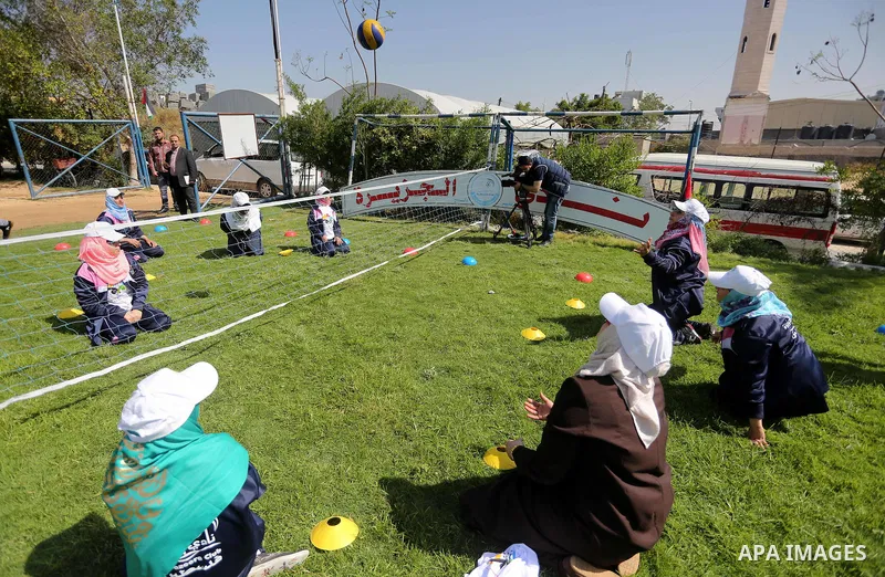Disabled Palestinians play sitting volleyball during a local sports championship organized by Al Jazeera club in Gaza City April 7, 2016. Photo by Mohammed Asad
