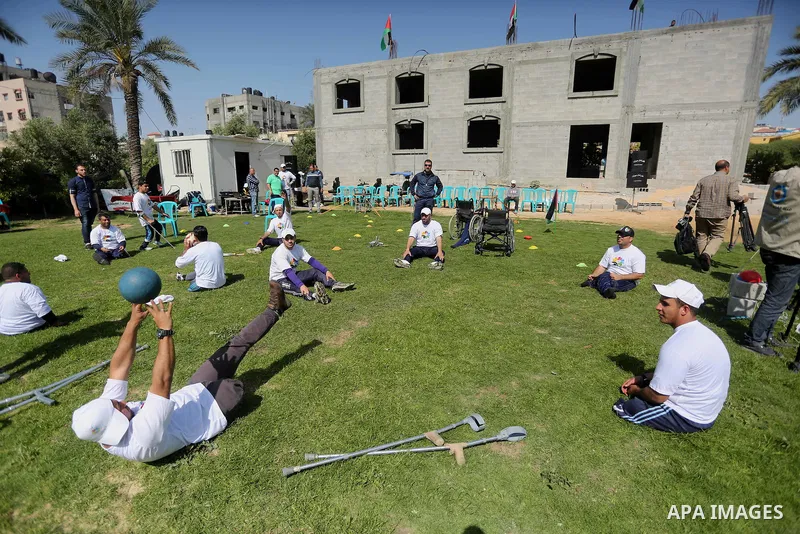 Disabled Palestinians play sitting volleyball during a local sports championship organized by Al Jazeera club in Gaza City April 7, 2016. Photo by Mohammed Asad
