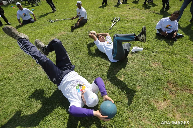 Disabled Palestinians play sitting volleyball during a local sports championship organized by Al Jazeera club in Gaza City April 7, 2016. Photo by Mohammed Asad