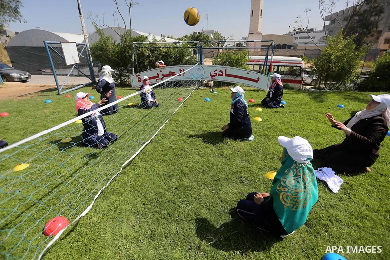 Disabled Palestinians play sitting volleyball during a local sports championship organized by Al Jazeera club in Gaza City April 7, 2016. Photo by Mohammed Asad