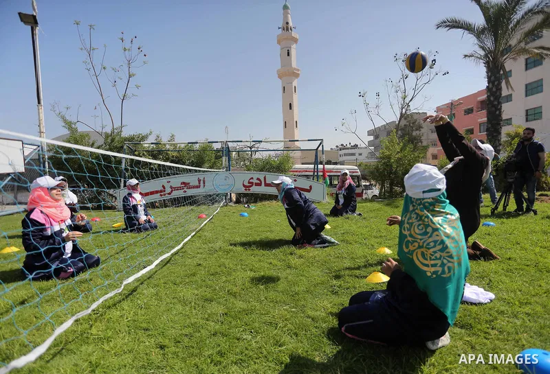 Disabled Palestinians play sitting volleyball during a local sports championship organized by Al Jazeera club in Gaza City April 7, 2016. Photo by Mohammed Asad