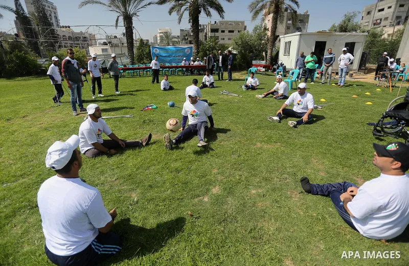 Disabled Palestinians play sitting volleyball during a local sports championship organized by Al Jazeera club in Gaza City April 7, 2016. Photo by Mohammed Asad