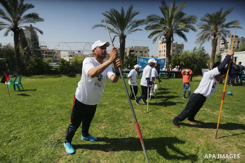 Disabled Palestinians play sitting volleyball during a local sports championship organized by Al Jazeera club in Gaza City April 7, 2016. Photo by Mohammed Asad