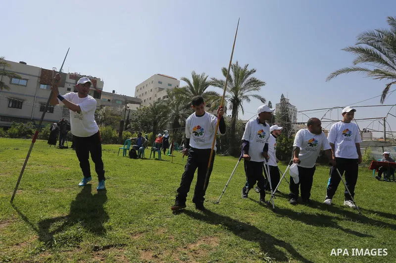 Disabled Palestinians play sitting volleyball during a local sports championship organized by Al Jazeera club in Gaza City April 7, 2016. Photo by Mohammed Asad