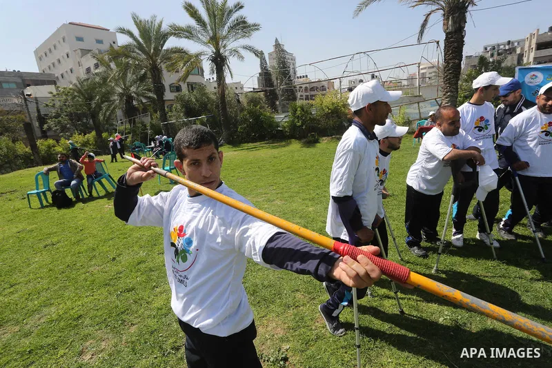 Disabled Palestinians play sitting volleyball during a local sports championship organized by Al Jazeera club in Gaza City April 7, 2016. Photo by Mohammed Asad