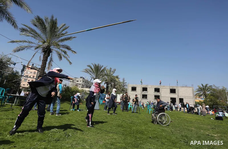Disabled Palestinians play sitting volleyball during a local sports championship organized by Al Jazeera club in Gaza City April 7, 2016. Photo by Mohammed Asad