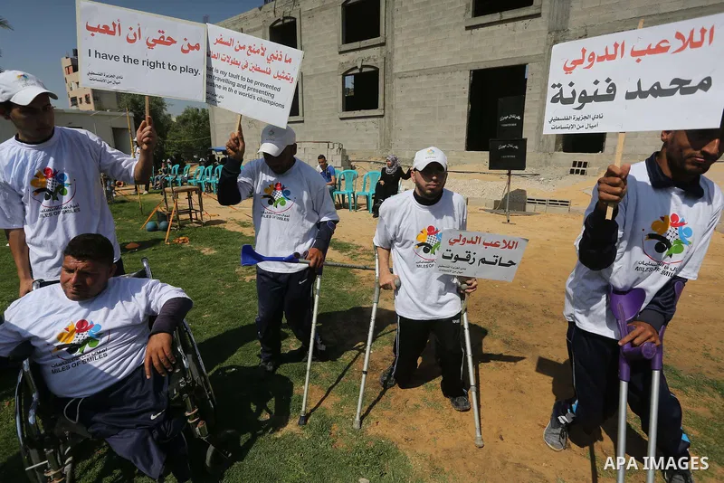 Disabled Palestinians play sitting volleyball during a local sports championship organized by Al Jazeera club in Gaza City April 7, 2016. Photo by Mohammed Asad