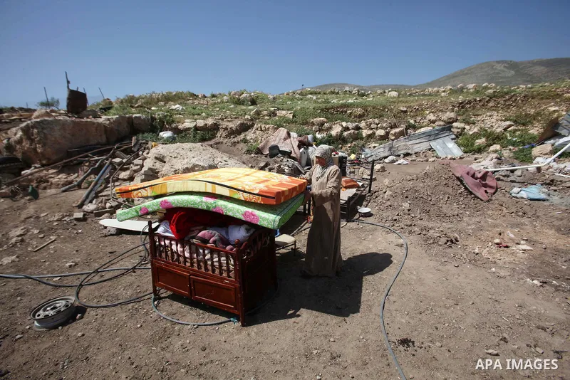 Palestinians inspect the rubble of a house that was demolished by Israeli bulldozers in the West Bank village of Khirbet Tana, south east of Nablus 07 April 2016. Khirbet Tana lies in an Israeli-declared military trainin...
