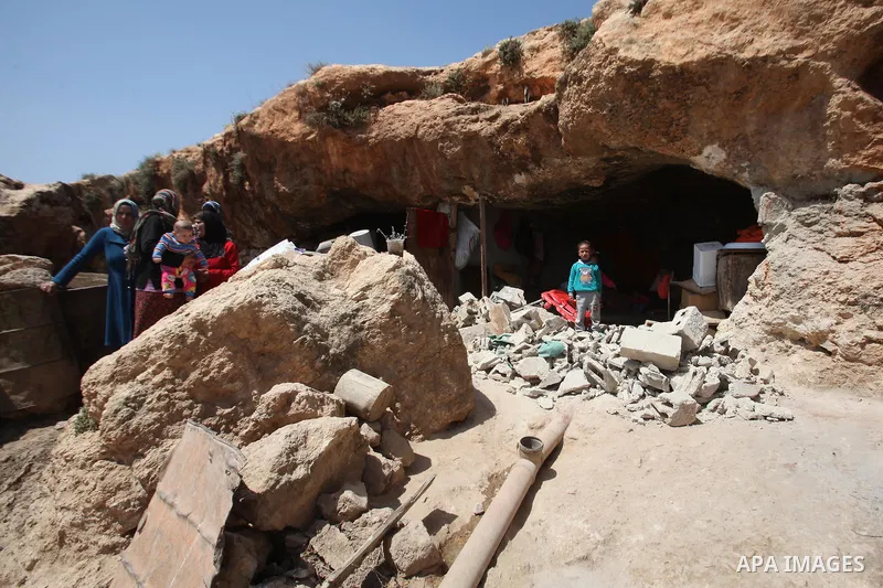 Palestinians inspect the rubble of a house that was demolished by Israeli bulldozers in the West Bank village of Khirbet Tana, south east of Nablus 07 April 2016. Khirbet Tana lies in an Israeli-declared military trainin...