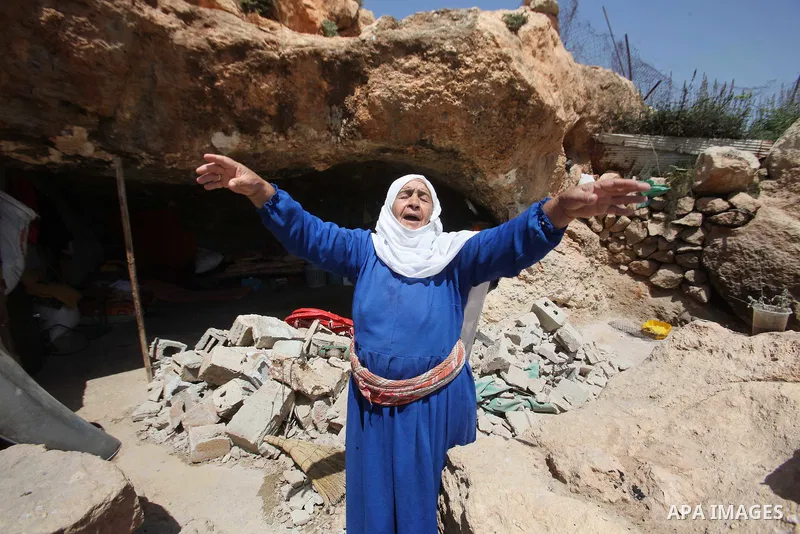 Palestinians inspect the rubble of a house that was demolished by Israeli bulldozers in the West Bank village of Khirbet Tana, south east of Nablus 07 April 2016. Khirbet Tana lies in an Israeli-declared military trainin...