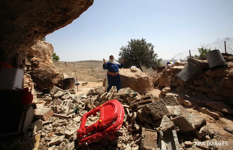 Palestinians inspect the rubble of a house that was demolished by Israeli bulldozers in the West Bank village of Khirbet Tana, south east of Nablus 07 April 2016. Khirbet Tana lies in an Israeli-declared military trainin...