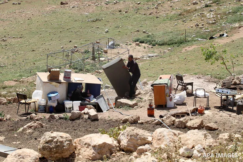 Palestinians inspect the rubble of a house that was demolished by Israeli bulldozers in the West Bank village of Khirbet Tana, south east of Nablus 07 April 2016. Khirbet Tana lies in an Israeli-declared military trainin...