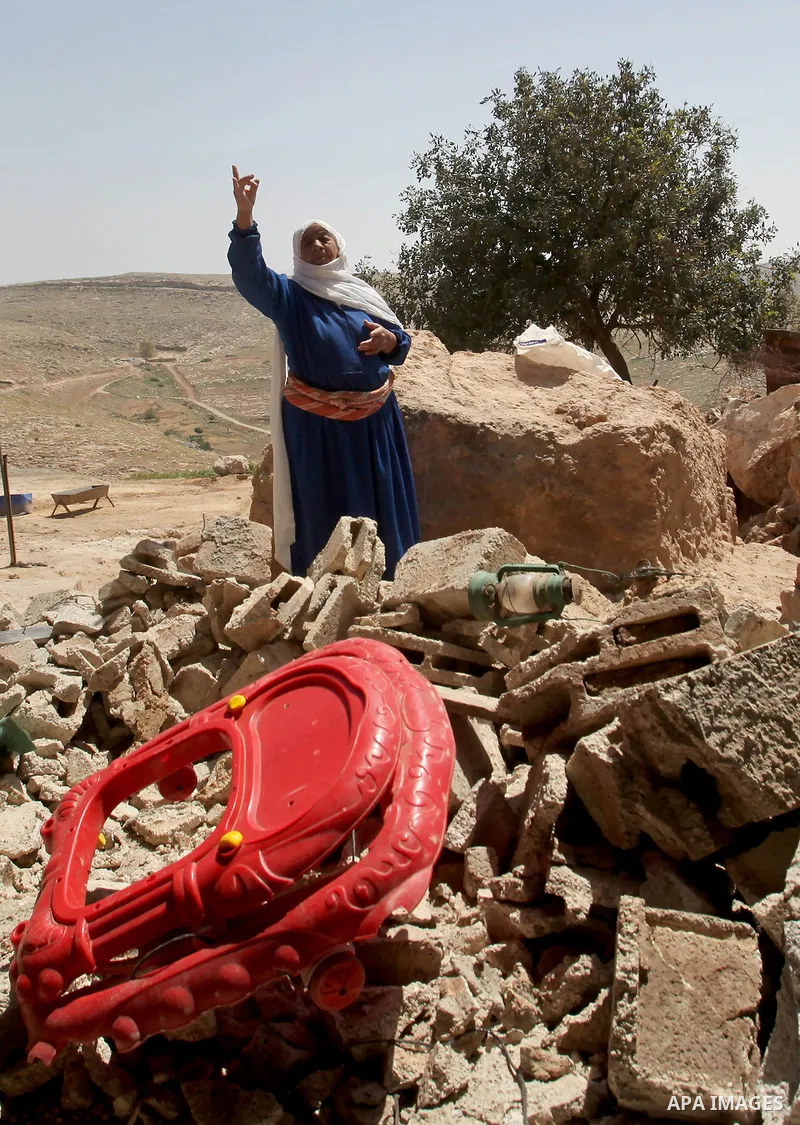 Palestinians inspect the rubble of a house that was demolished by Israeli bulldozers in the West Bank village of Khirbet Tana, south east of Nablus 07 April 2016. Khirbet Tana lies in an Israeli-declared military trainin...