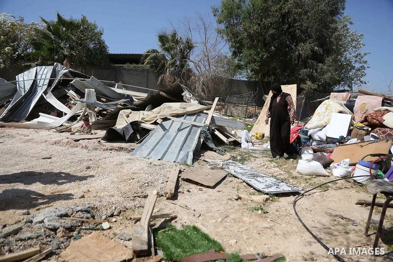 A woman from the Arab Jahalin Bedouin community inspects debris of homes in the West Bank Bedouin camp of al-Khan al-Ahmar on April 7, 2016 after Israeli authorities demolished four houses that they said were built witho...